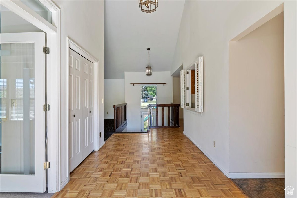 Corridor featuring baseboards and a high ceiling