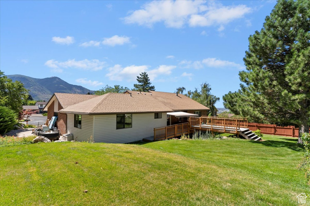 Back of house with a deck with mountain view