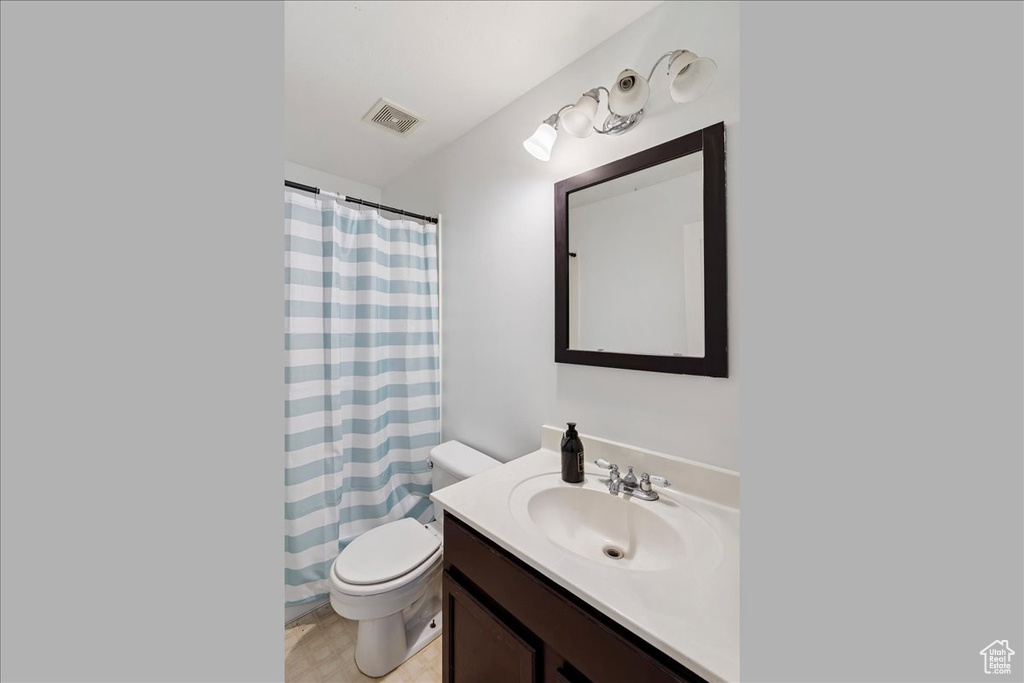 Bathroom featuring vanity and curtained shower
