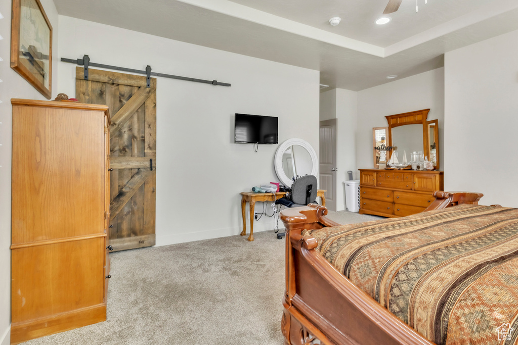 Carpeted bedroom featuring a barn door and recessed lighting