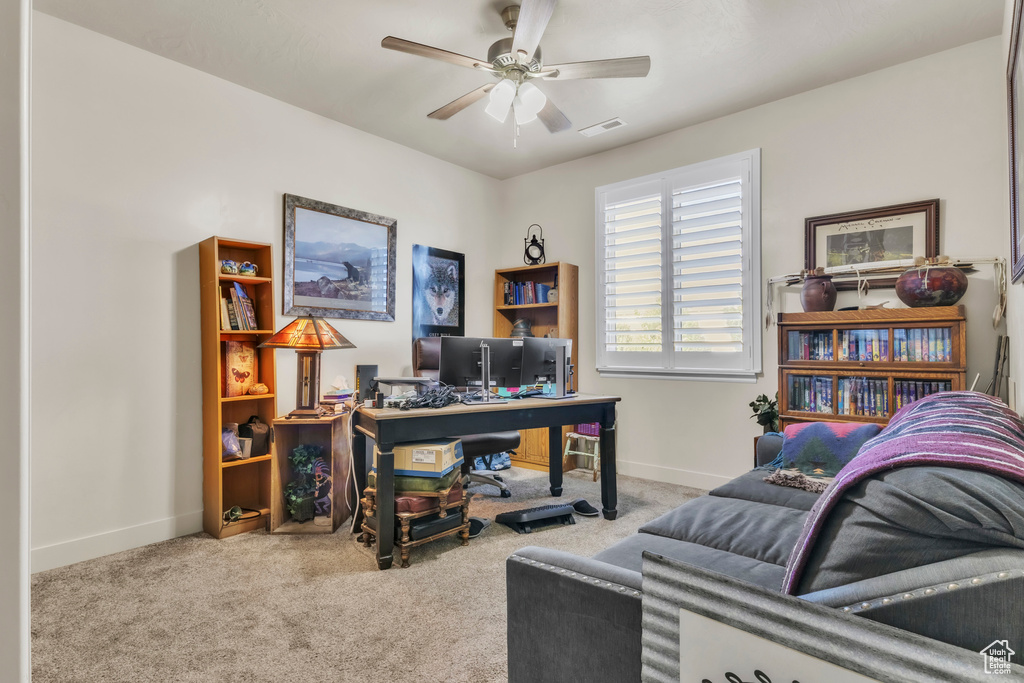 Office space with carpet and a ceiling fan