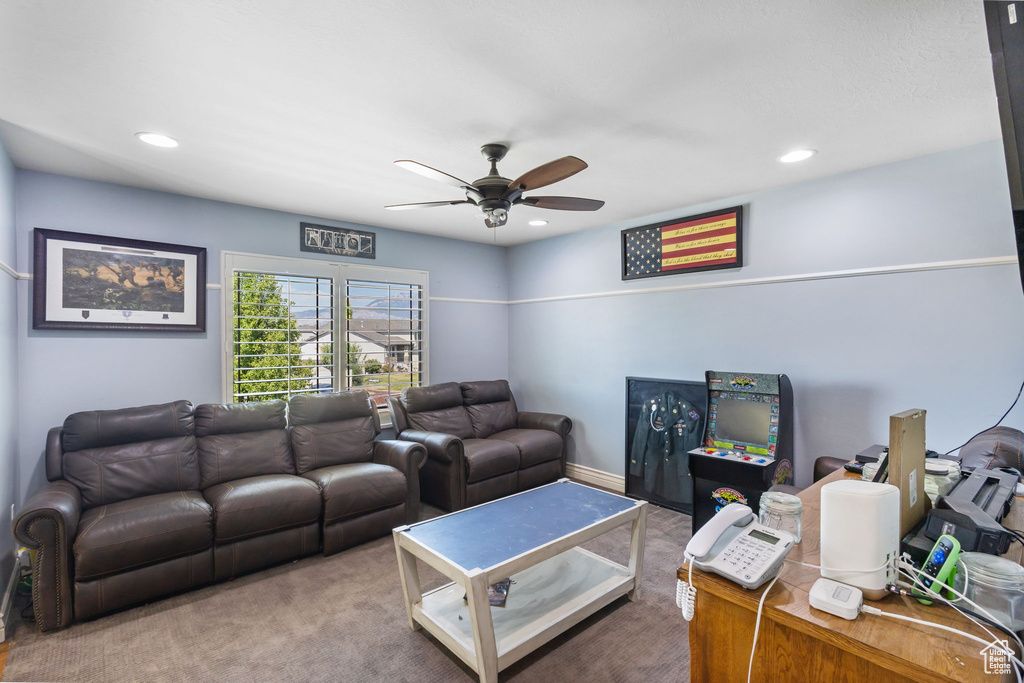 Living room with ceiling fan, carpet floors, and recessed lighting