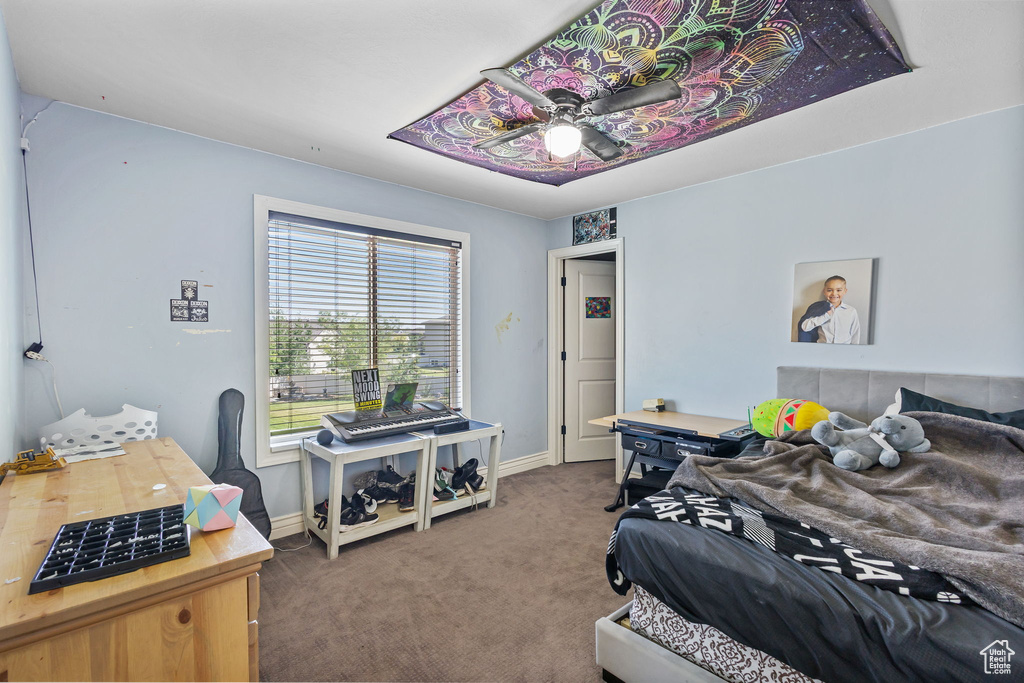 Bedroom featuring carpet and baseboards