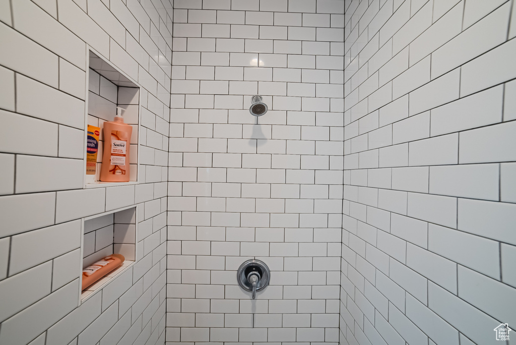 Full bath featuring tiled shower