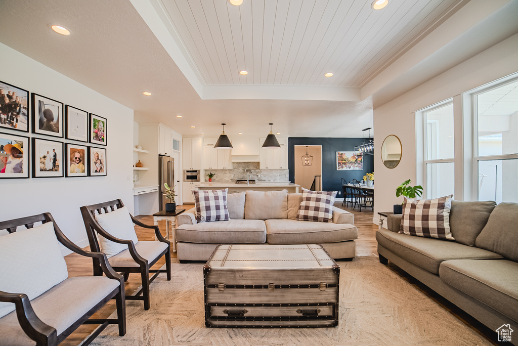 Living room with a raised ceiling and recessed lighting