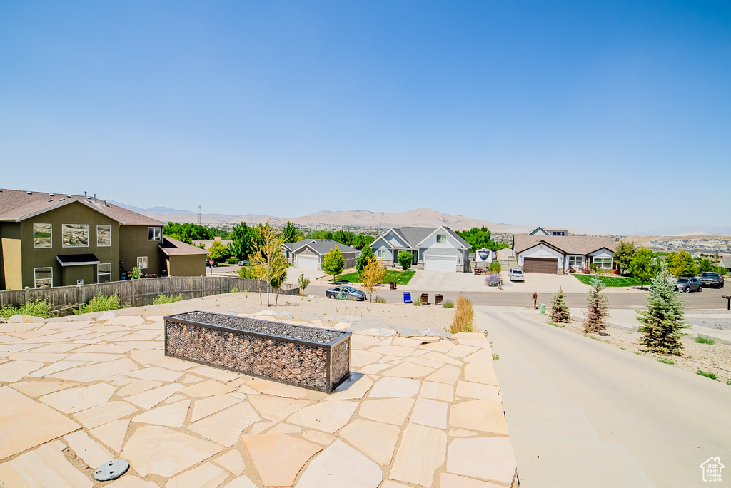 View of patio / terrace featuring a residential view and a mountain view
