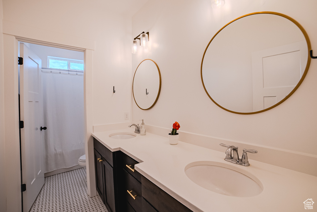 Full bathroom with double vanity and shower / bath combination with curtain