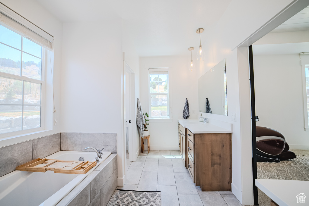 Full bathroom with vanity, a garden tub, and tile patterned flooring