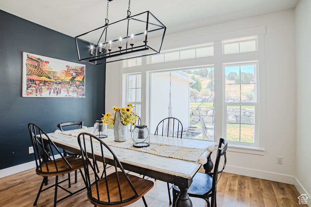 Dining room featuring wood finished floors and a chandelier