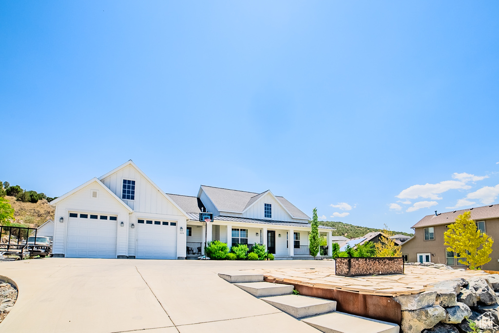 Modern farmhouse style home with board and batten siding and driveway