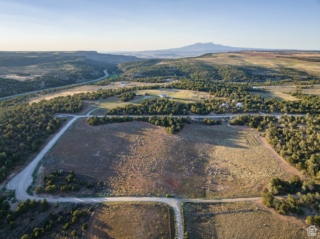Aerial view of property and surrounding area featuring a mountain backdrop