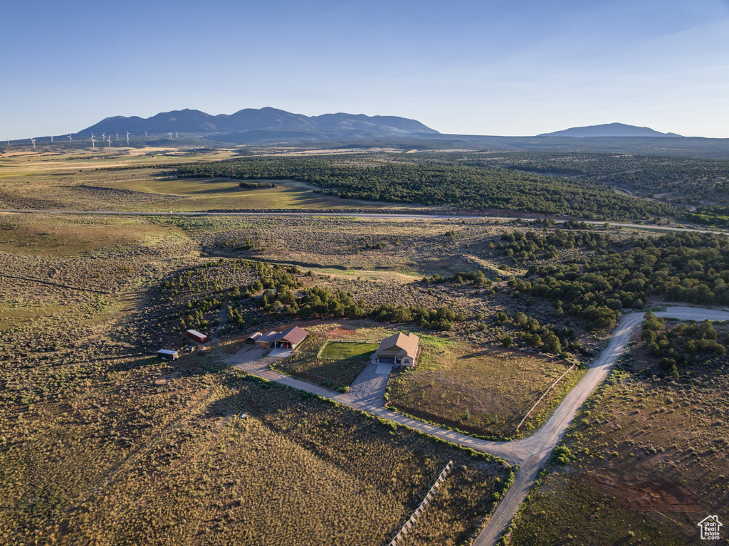 Aerial view of property and surrounding area featuring mountains and rural landscape