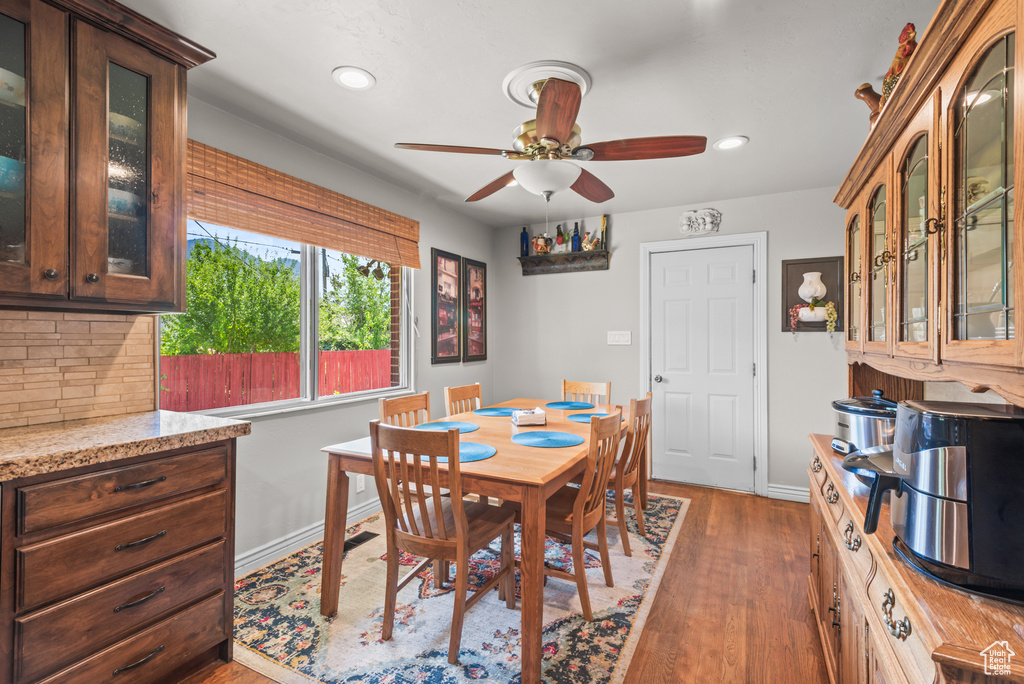 Dining room featuring a ceiling fan, wood finished floors, and recessed lighting