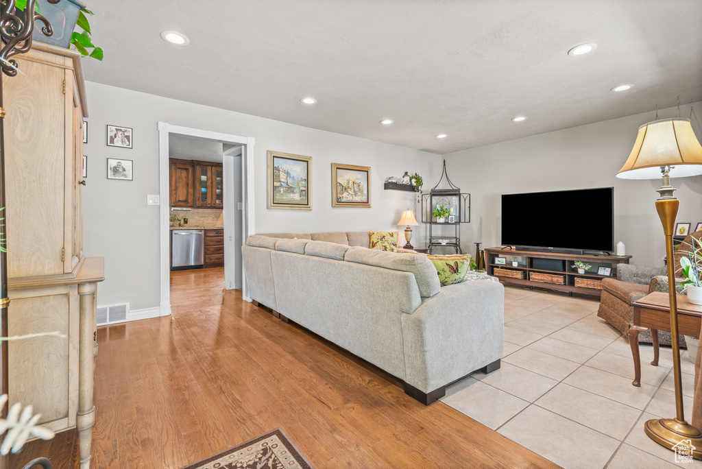 Living area with recessed lighting and light wood-type flooring