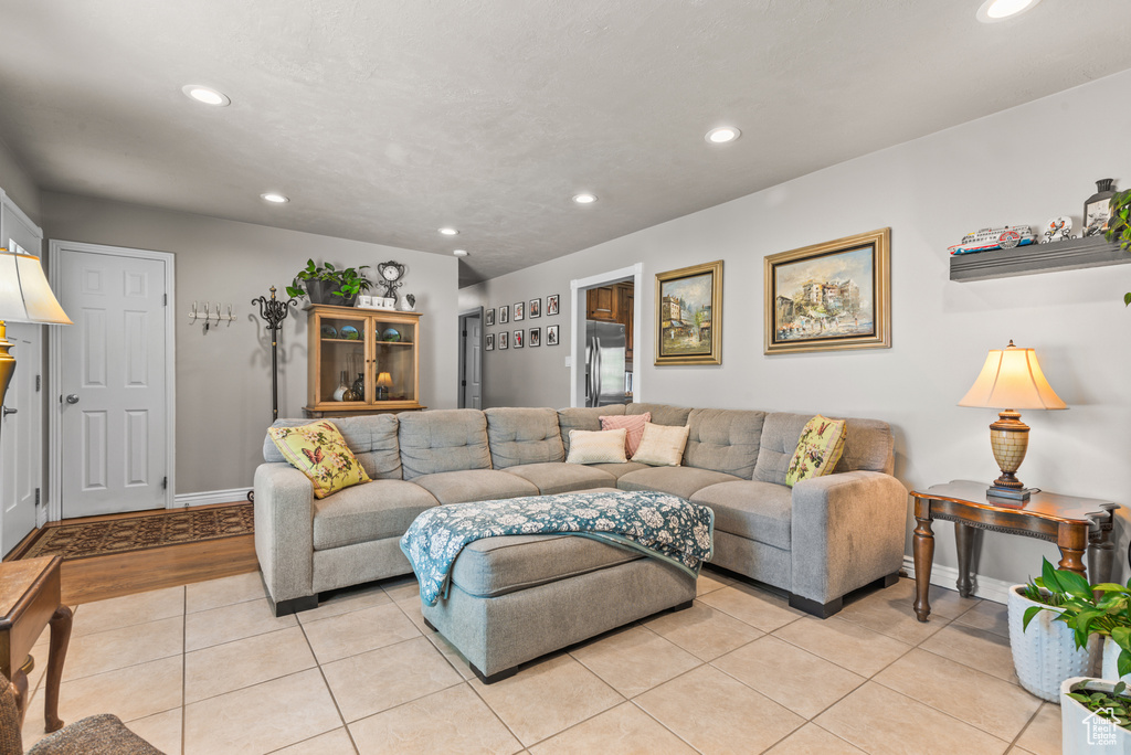 Living area with recessed lighting and light tile patterned floors