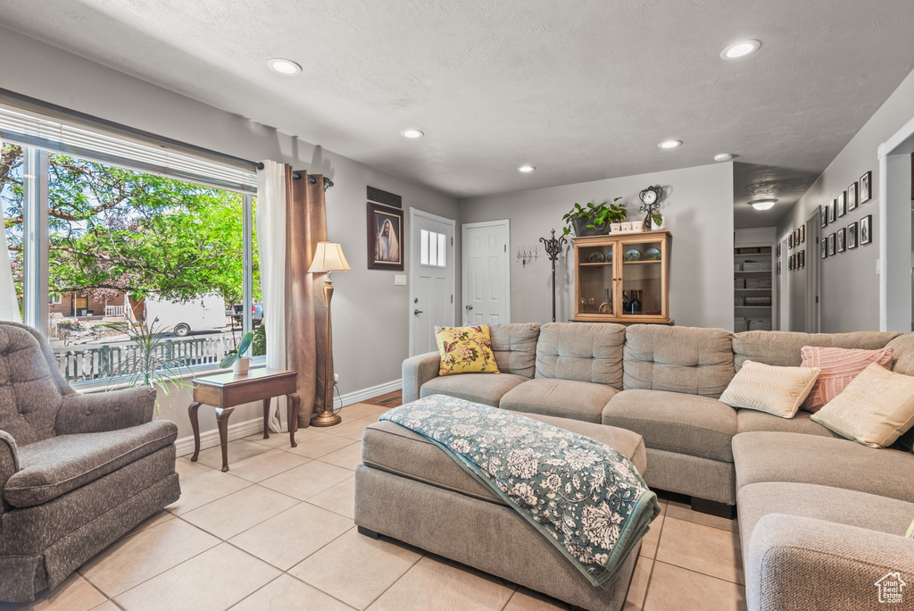Living area featuring light tile patterned floors and recessed lighting