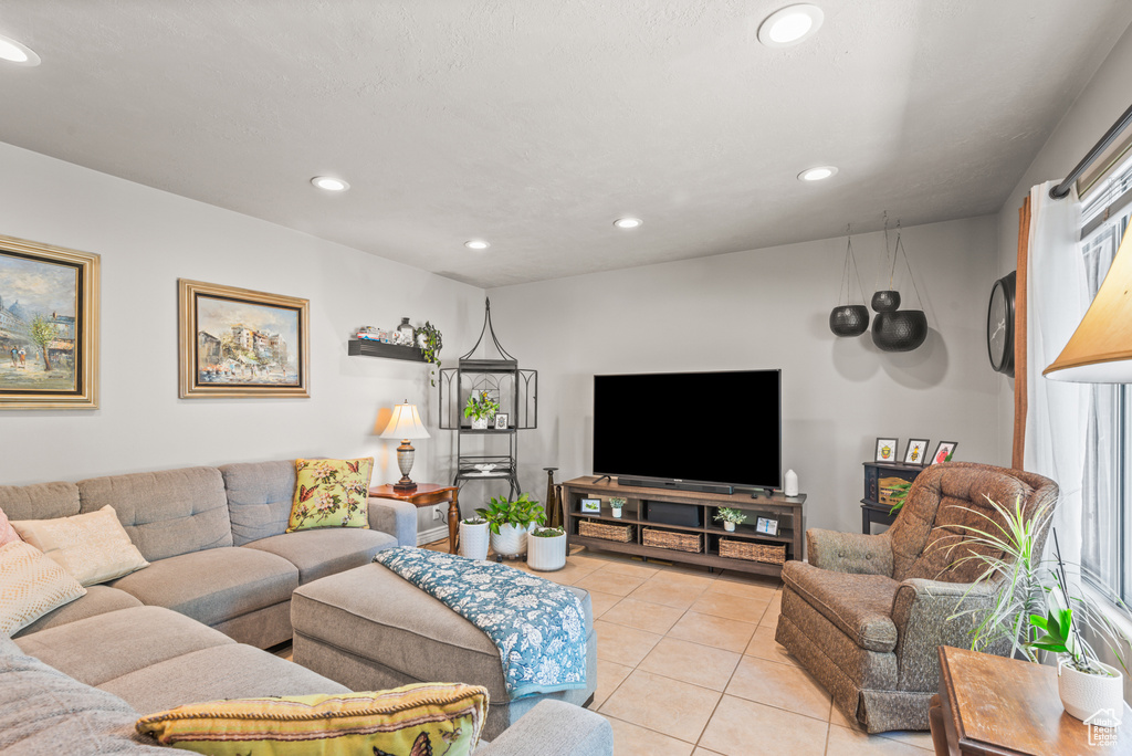 Living area with recessed lighting and light tile patterned flooring