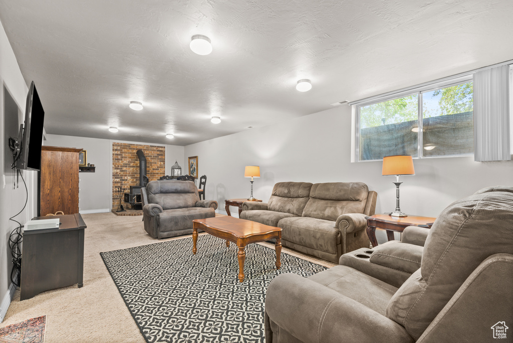 Living area featuring carpet floors and a wood stove
