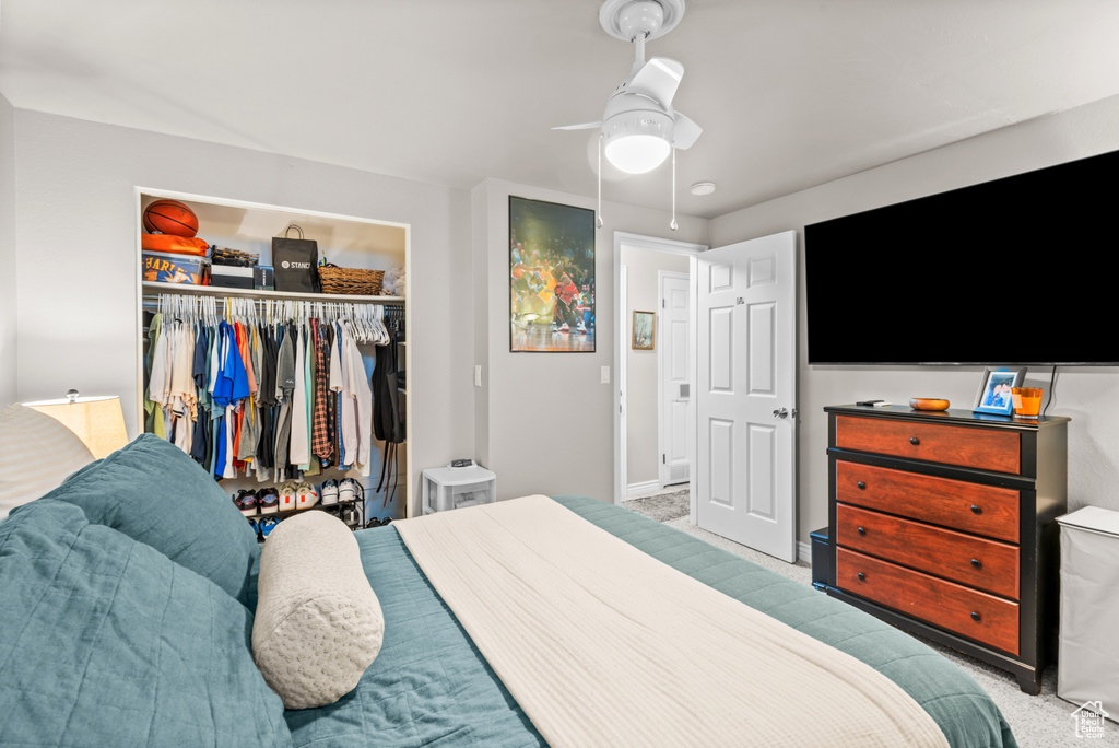 Bedroom featuring carpet flooring, a closet, and ceiling fan