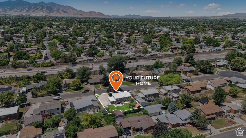 Aerial perspective of suburban area featuring a mountainous background