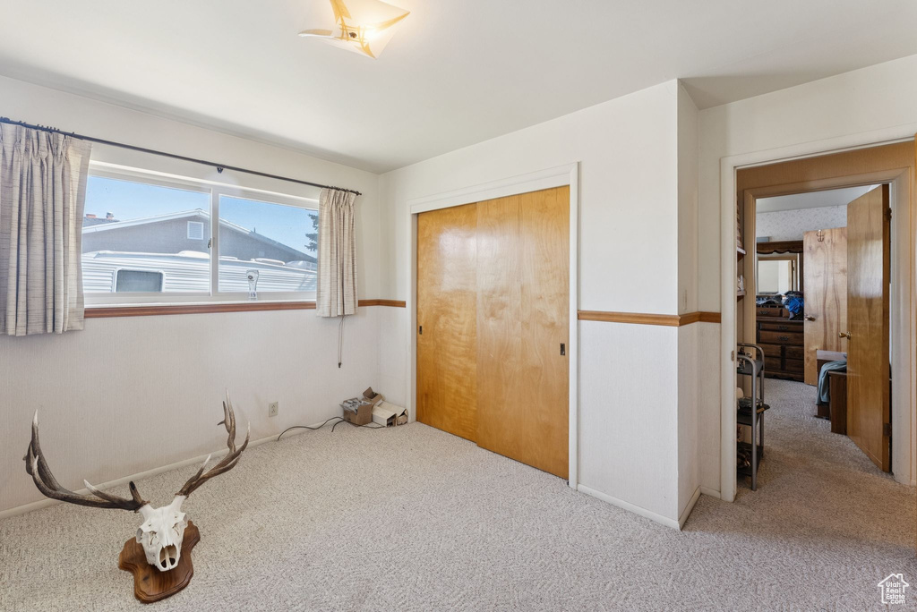 Unfurnished bedroom with carpet floors and a closet