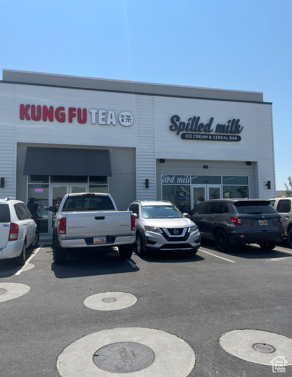 View of commercial property with uncovered parking
