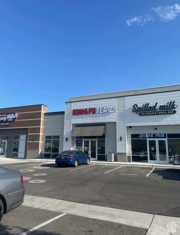 View of commercial property with uncovered parking