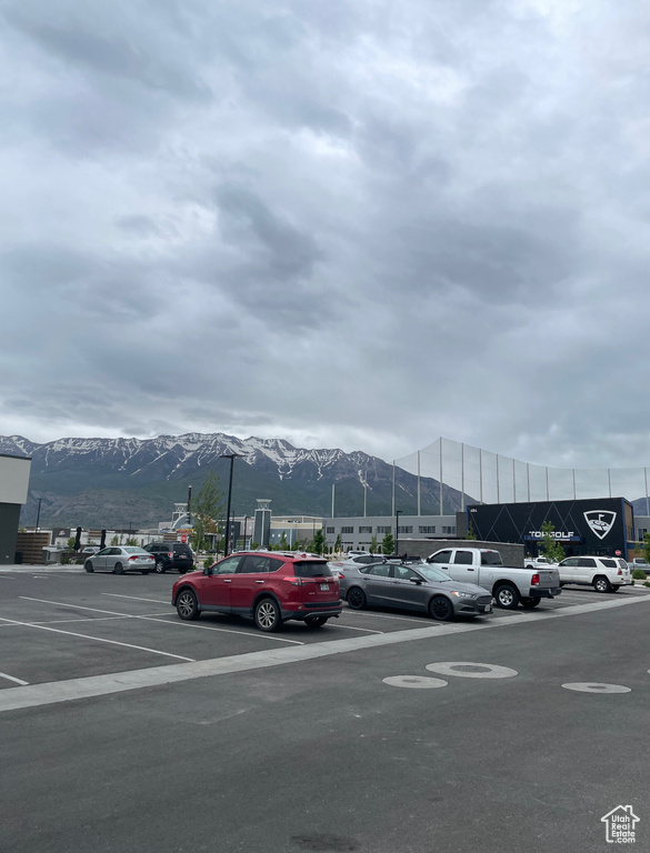 Uncovered parking lot featuring a mountain view