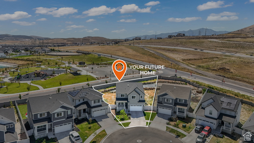 Aerial view of residential area featuring mountains and property boundaries highlighted