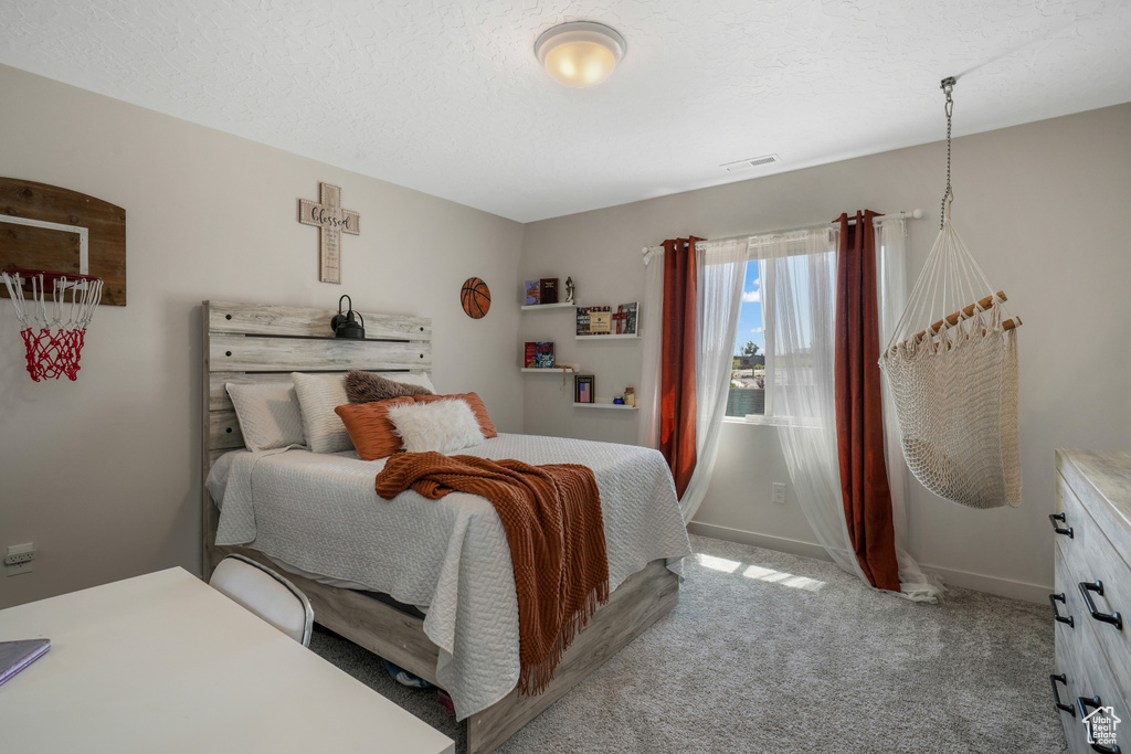 Carpeted bedroom with baseboards