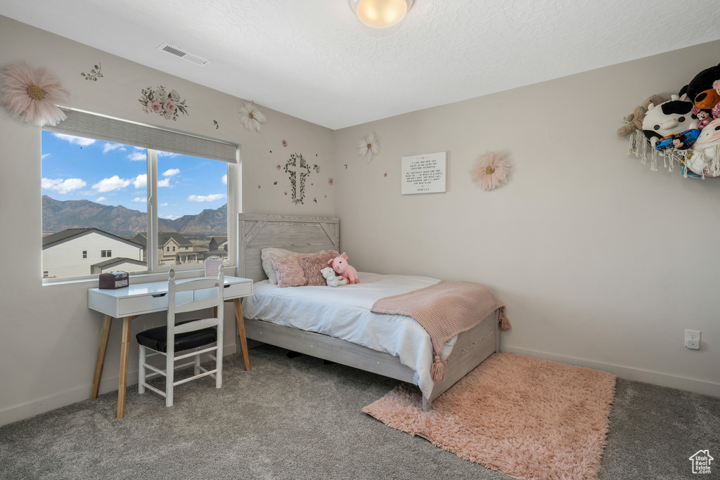 Bedroom with a mountain view and carpet floors