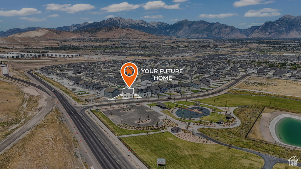 Aerial view of property's location featuring a mountainous background and nearby suburban area