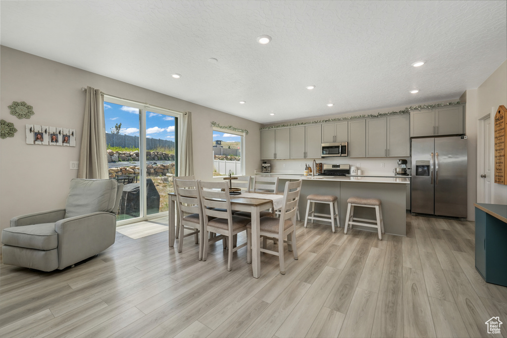 Dining space with light wood-style flooring and recessed lighting