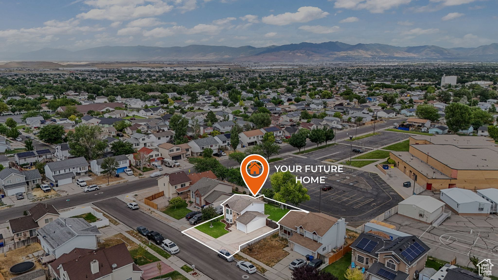 Aerial perspective of suburban area featuring a mountainous background