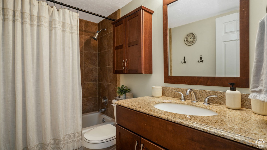 Bathroom featuring vanity and shower / tub combo with curtain