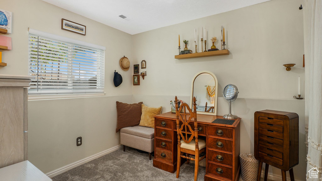Carpeted office space featuring baseboards