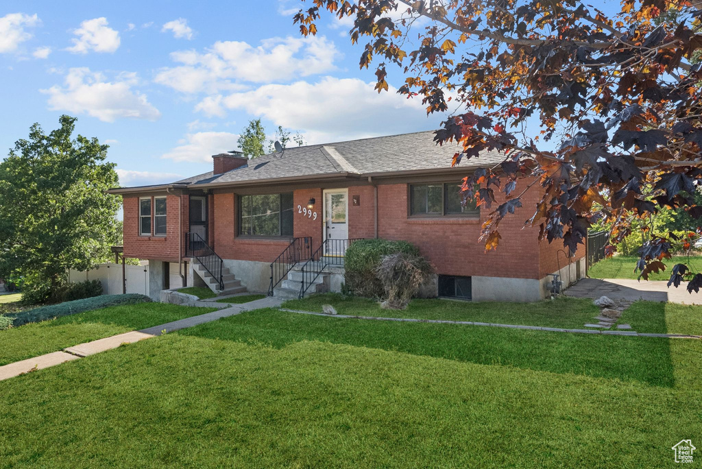 View of front facade featuring brick siding and an attached garage
