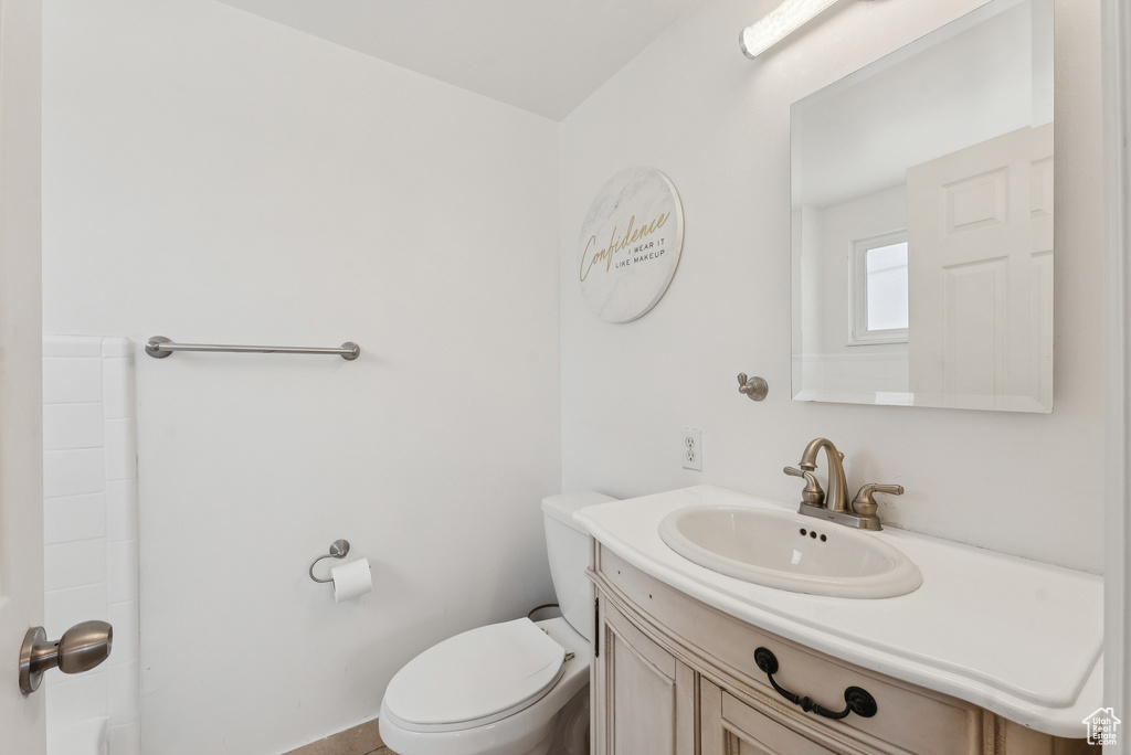 Bathroom featuring vanity and toilet