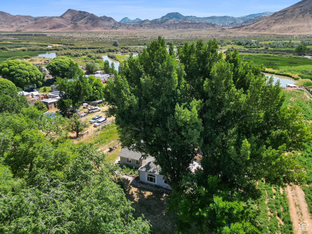 Aerial view of property and surrounding area featuring a water and mountain view