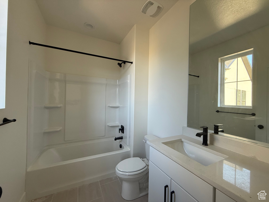 Full bathroom featuring vanity, shower / tub combination, and tile patterned floors