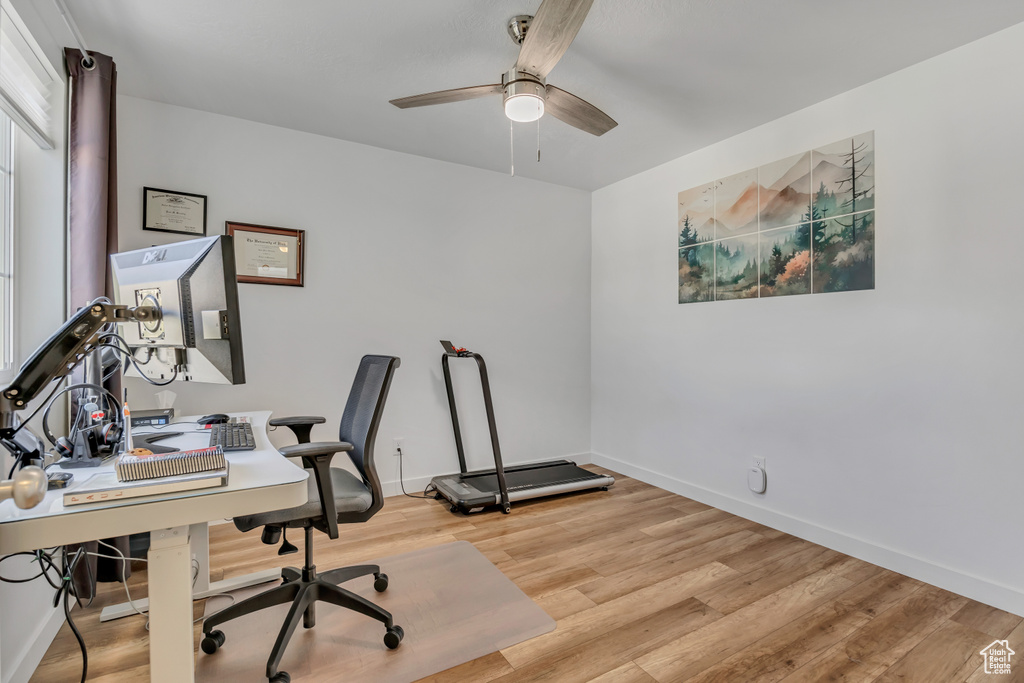 Home office featuring a ceiling fan and light wood-style floors