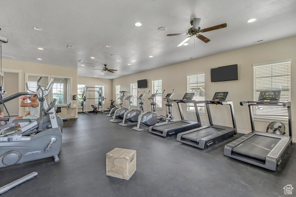 Workout area with a ceiling fan and recessed lighting