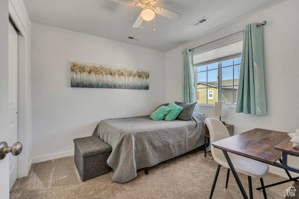 Bedroom featuring carpet floors, ceiling fan, and a closet