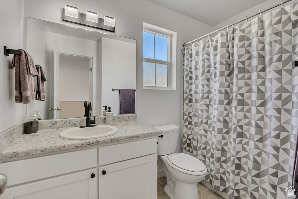 Full bath featuring vanity and curtained shower