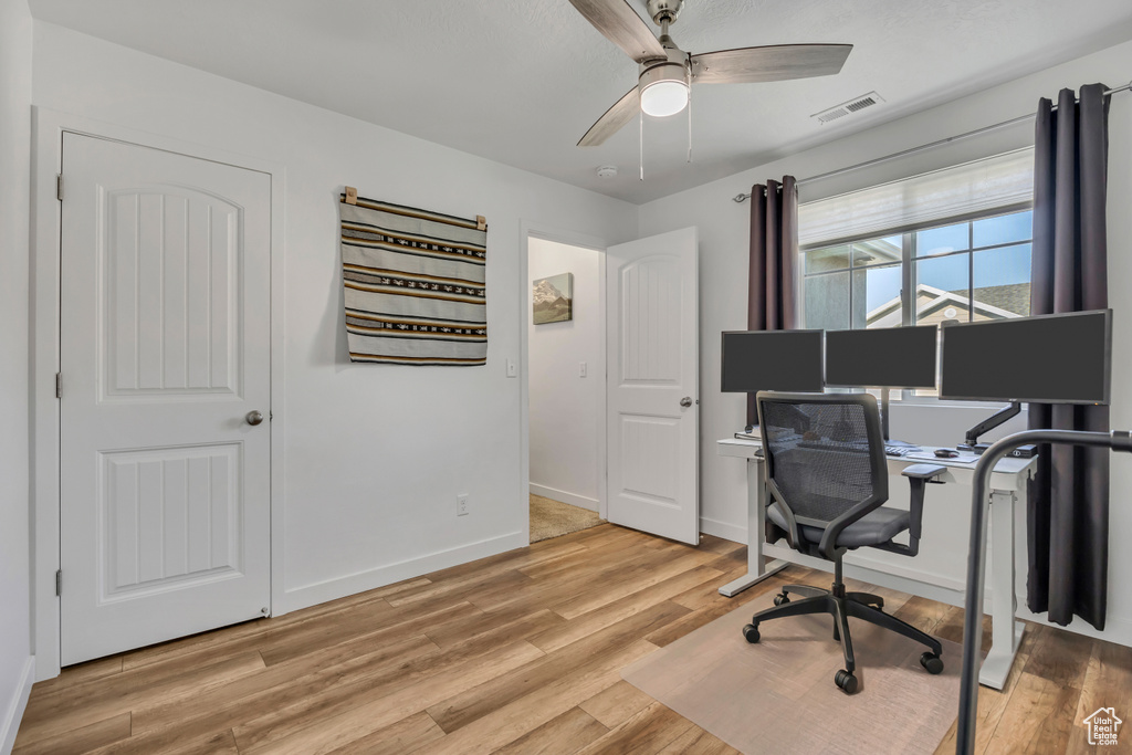 Office area featuring ceiling fan and light wood-type flooring