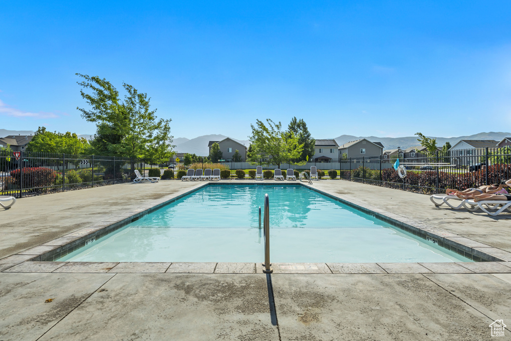 Community pool featuring a patio and a residential view