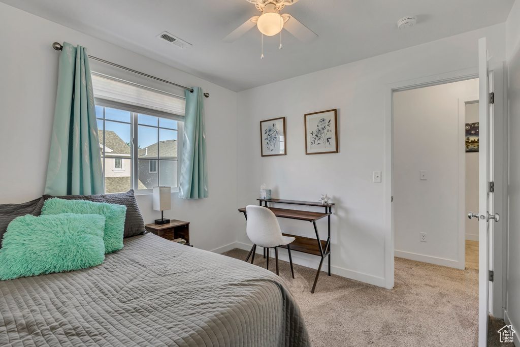 Carpeted bedroom with baseboards and ceiling fan