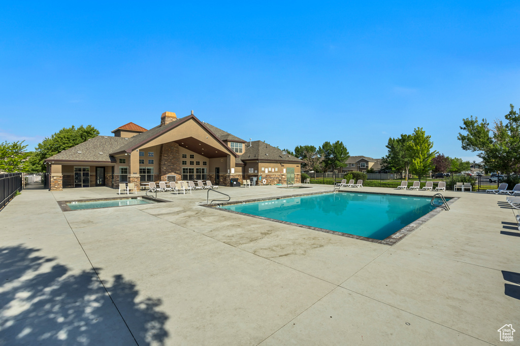 Community pool featuring a patio
