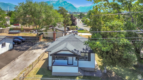 Aerial view of property and surrounding area with a mountainous background
