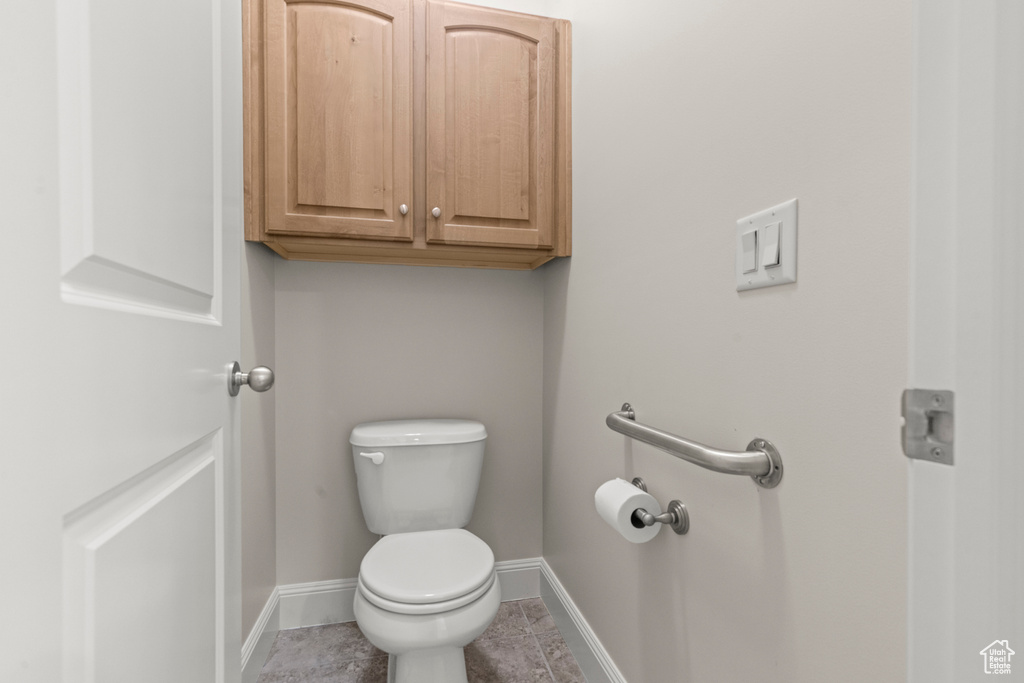 Bathroom with baseboards and tile patterned flooring